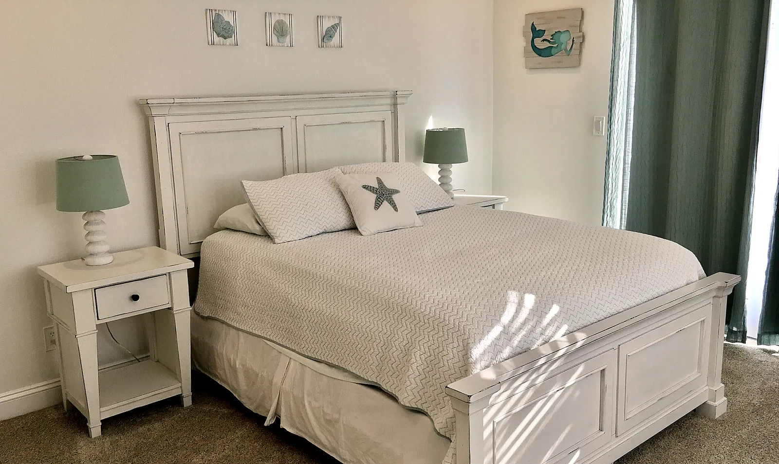 Bedroom 2 with queen bed and slider doors to patio